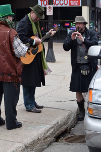 Musicians serenade police officers watching the parade from an SUV