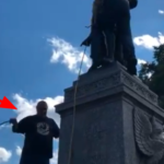 Forcia (lower left) is seen preparing a rope that was used to tear down the statue. (Twitter/@maxnesterak)