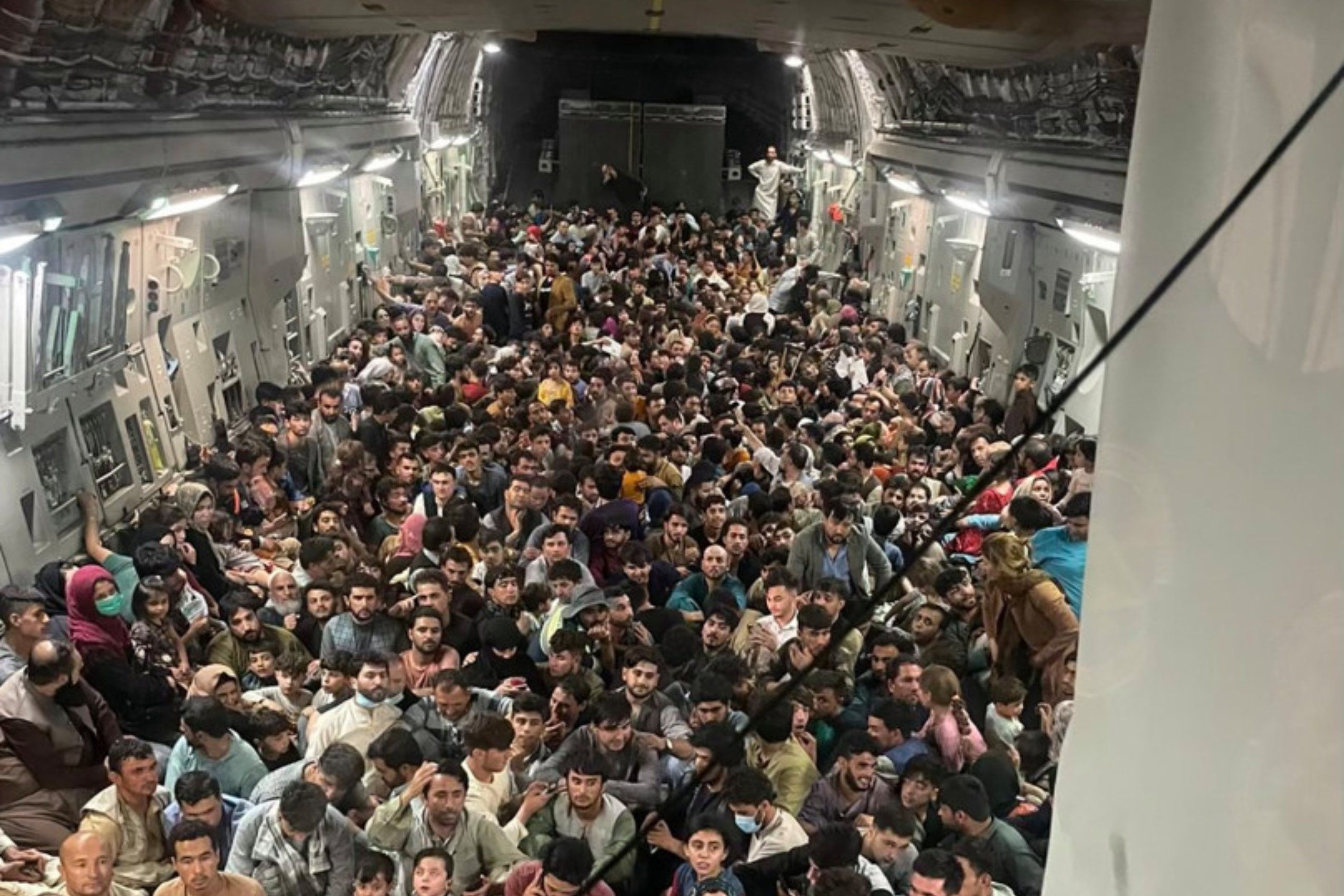 Afghan refugees fill an American C-17 plane.