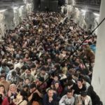 Afghan refugees fill an American C-17 plane.