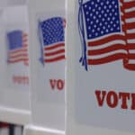 A row of voting booths at a polling station. (Shutterstock)