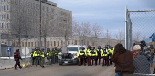 Protesters and police outside of the Whipple Federal Building in February. The building serves as a local headquarters for ICE. (Photo by Chris Birt)