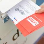 Ballots are dropped off at a collection box/Shutterstock