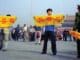 A Chinese policeman (right) approaches Falun Gong practitioners in Tiananmen Square as they hold a banner that reads "Truthfulness Compassion Forbearance."
