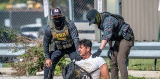 Immigration agents detain a man during a protest outside an ICE processing center in Broadview, Illinois, in September 2025.