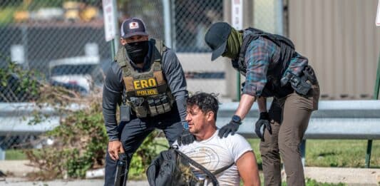Immigration agents detain a man during a protest outside an ICE processing center in Broadview, Illinois, in September 2025.