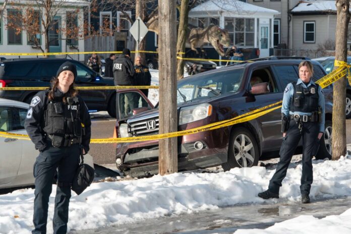 Minneapolis police officers stand by the scene where Renee Good was killed in January 2026.