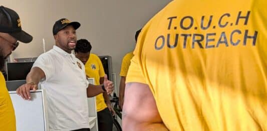 Muhammad Abdul-Ahad, the founder of T.O.U.C.H. Outreach in Minneapolis, meets with his group of "violence interrupters" before they canvassed crime-prone areas of the city on a recent day.