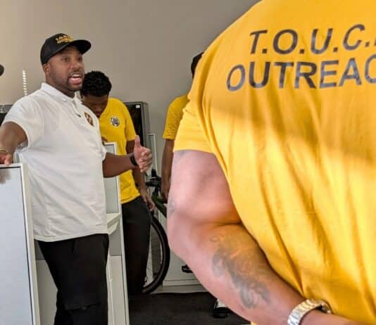 Muhammad Abdul-Ahad, the founder of T.O.U.C.H. Outreach in Minneapolis, meets with his group of "violence interrupters" before they canvassed crime-prone areas of the city on a recent day.