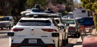 Waymo cars parked along a street in Mountain View, Calif.