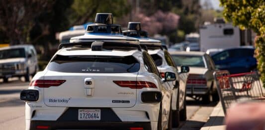 Waymo cars parked along a street in Mountain View, Calif.