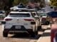 Waymo cars parked along a street in Mountain View, Calif.